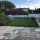 Rear garden with interlocking lawns and mirror trellis boundary panels Added by Belinda Macdonald