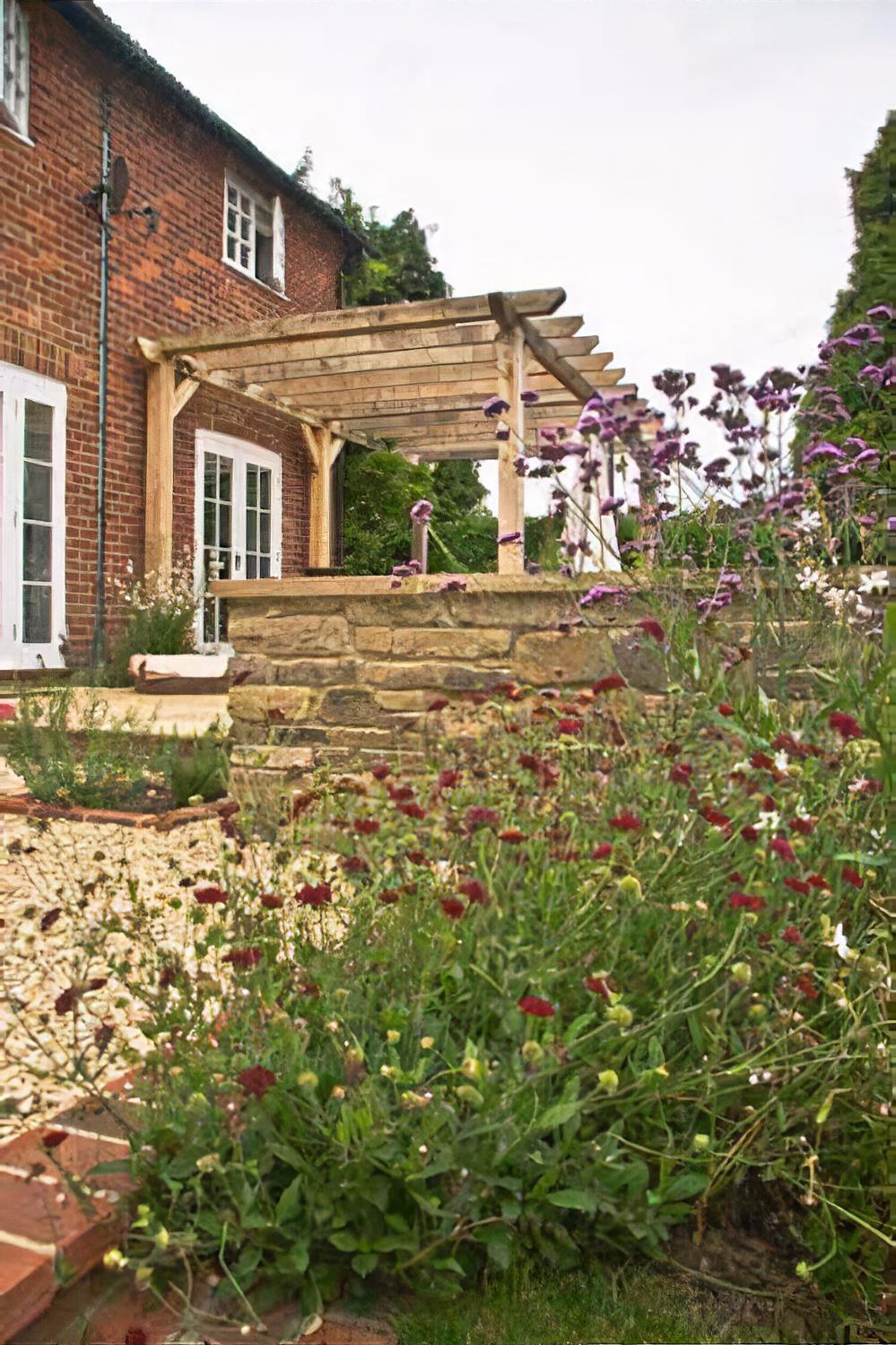 Town garden with raised pool, Haslemere, Surrey by Hampshire garden designer Janet Bligh